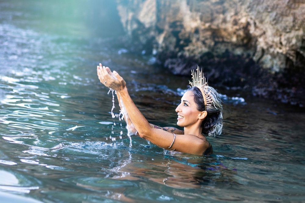 Spiritual Woman wearing goddess crown in the water