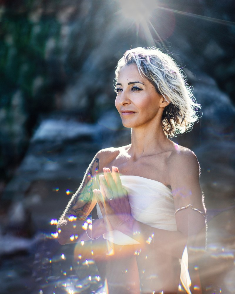 Sunlight on woman with palms together