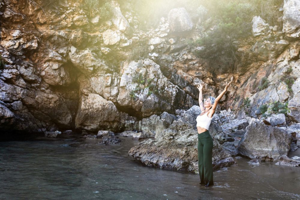 Ethereal woman with arms in the air, embracing the sky