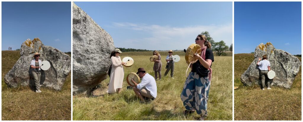 Veruschka Baudo and retreat participants playing drums in a shamanic ceremony among the ancient stones at Avebury stone circle