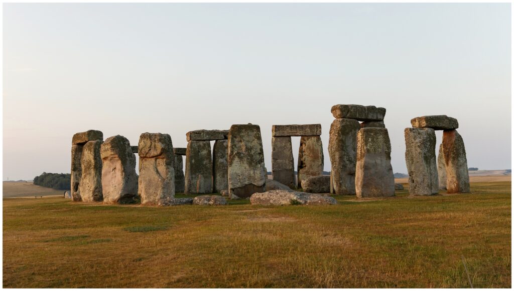 Ancient Stonehenge stone circle at sunrise during a summer solstice pilgrimage
